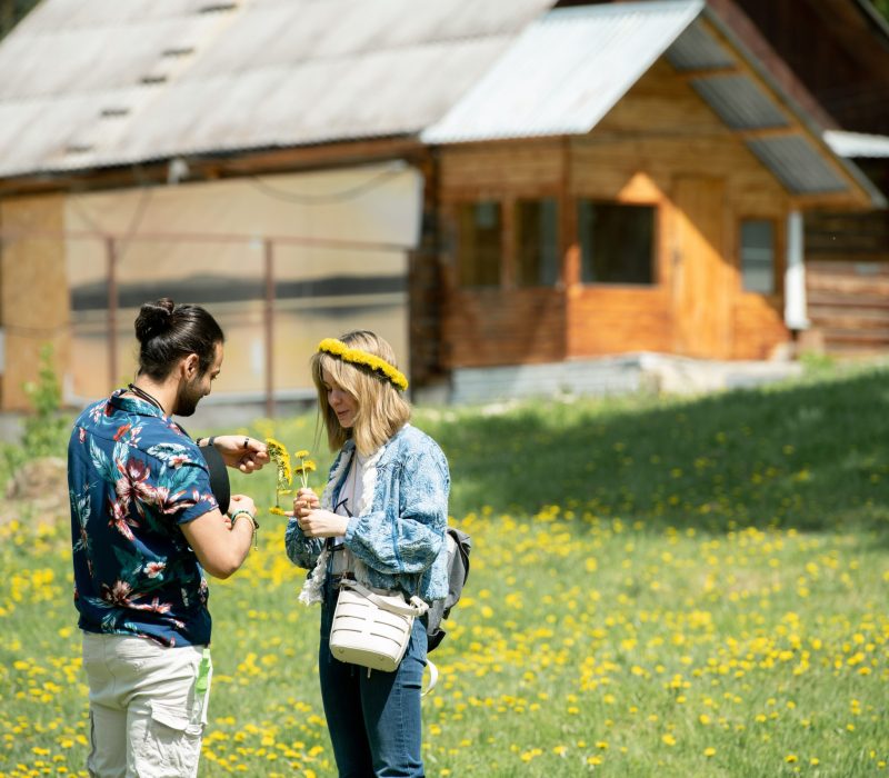 Young man making wrench with girlfriend while they spending weekend in countryside